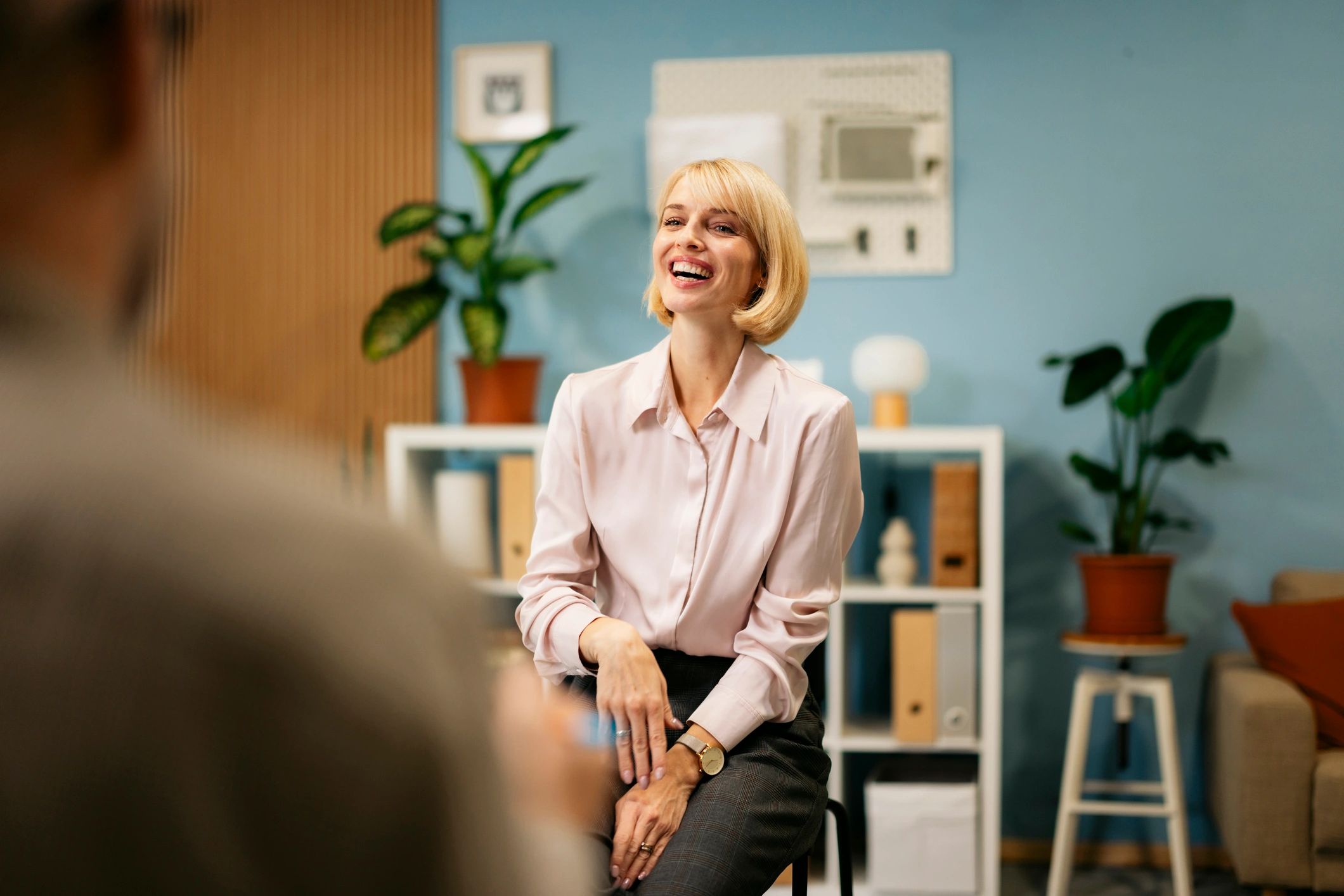Health coach speaking with a client in a supportive, professional setting
